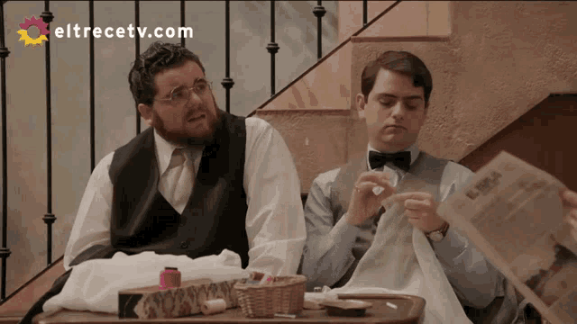two men sit at a table with eltrecetv.com on the bottom right