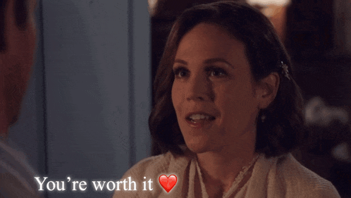 a woman with a heart and the words you 're worth it above her
