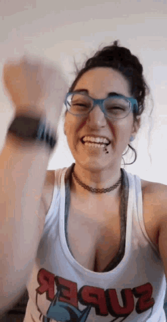 a woman wearing a tank top that says jesus on it
