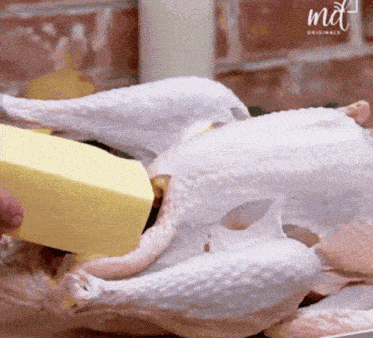 a piece of butter is being poured on a turkey with the word md on the bottom