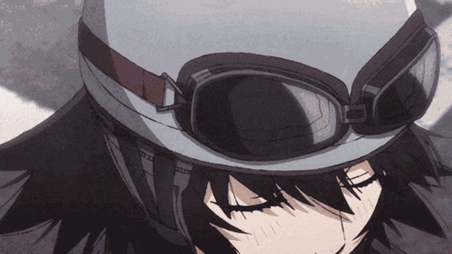 a close up of a person wearing a helmet and goggles with their eyes closed