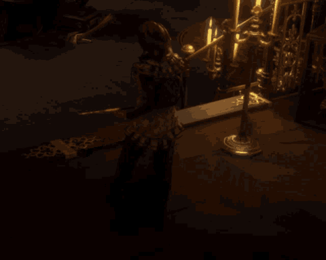 a person in a dark room with candles on a table