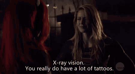 a woman with red hair is talking to another woman with blonde hair and the words x-ray vision you really do have a lot of tattoos