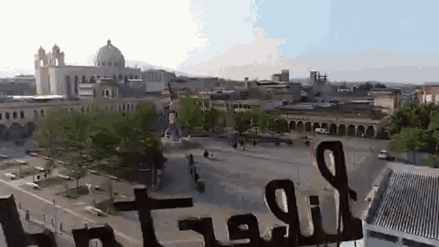 an aerial view of a city with a sign in the foreground that says ' a ' on it