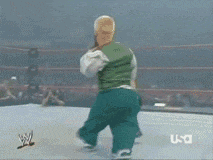 a man in a green vest is wrestling another man in a white vest