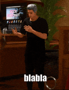 a man in a black shirt is standing in front of a good coconut machine