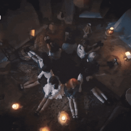 a group of girls are laying on a rug in a circle