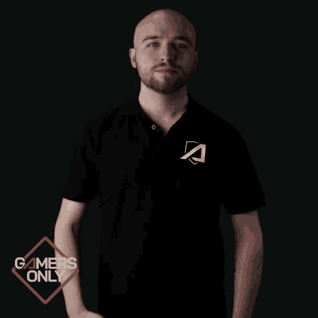 a man in a black shirt is pointing to his chest with a gamers only logo in the background