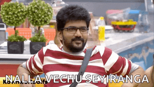 a man wearing glasses and a red and white striped shirt with the words nalla vechu seyiranga on the bottom