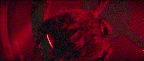 a close up of a werewolf with its mouth open in a dark room