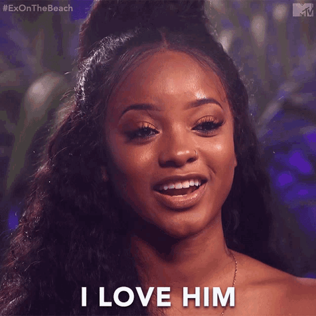 a woman says " i love him " while looking at the camera