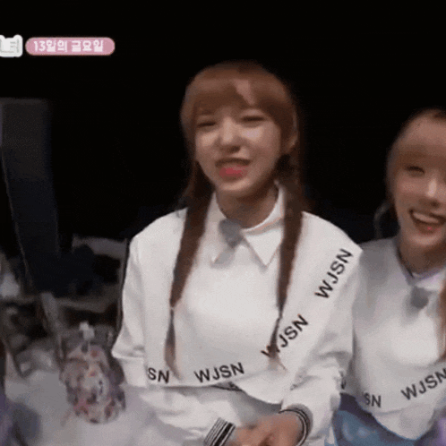 a girl wearing a white sweater that says wjsn