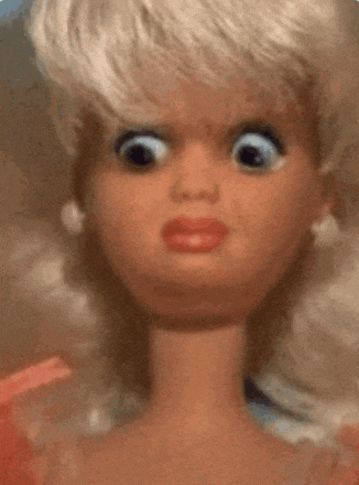 a close up of a barbie doll making a surprised face