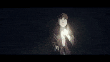 a boy and a girl are standing in the dark with a flashlight