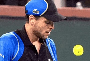 a man wearing a blue hat with a lacoste logo