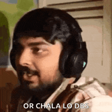a man with a beard is wearing headphones and making a face .
