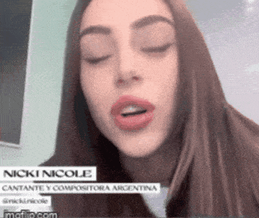 a close up of a woman 's face with her eyes closed and the name nicki nicole on the bottom