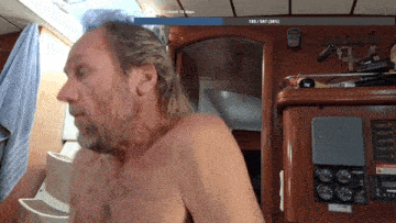 a shirtless man stands in front of a screen that says 188/547 ( 34 % ) on it