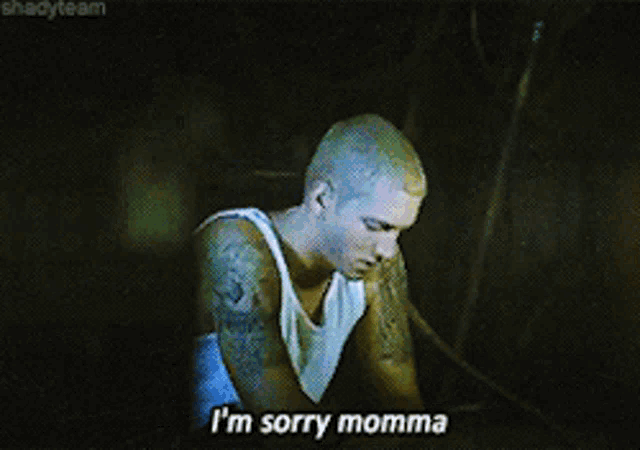 a man in a white tank top says " i 'm sorry momma " while smoking a hookah