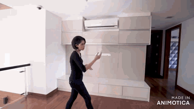 a woman standing in a room with the words made in animotica on the bottom right