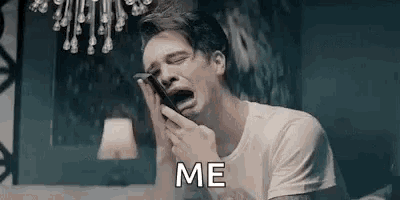 a man is crying while holding a cell phone in his hands .