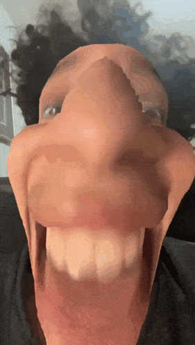 a close up of a person making a funny face with their mouth open