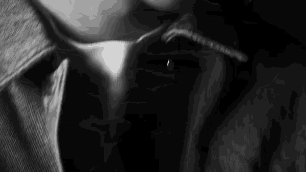 it is a black and white photo of a person 's neck and collar .