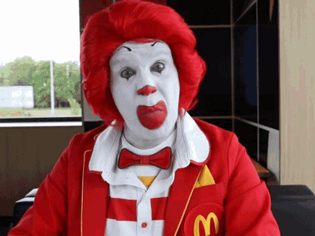 a man dressed as mcdonald 's ronald mcdonald is making a funny face