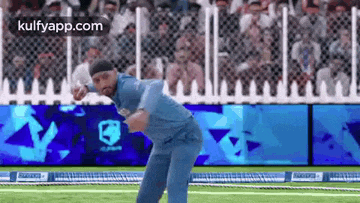 a man is throwing a ball on a cricket field .