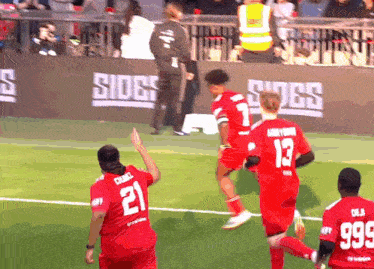 a soccer player with the number 21 on his jersey is running on the field