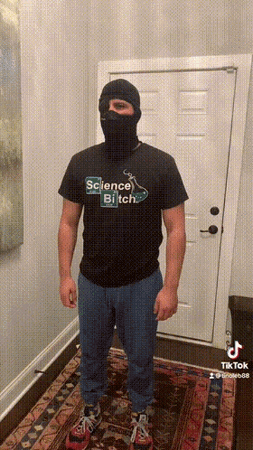 a man wearing a mask and a science bitch t-shirt