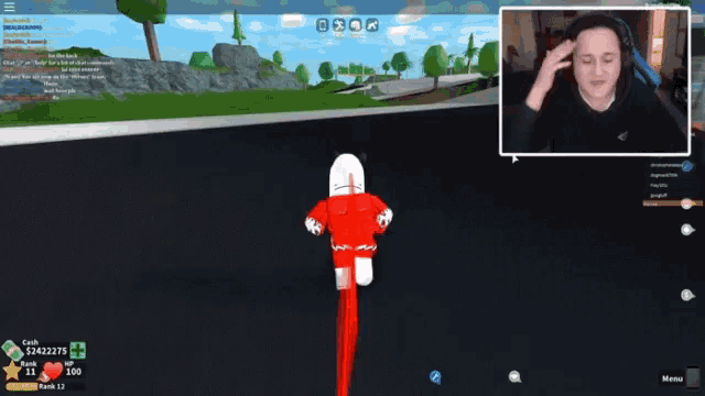 a man playing a video game with a red and white character in the background