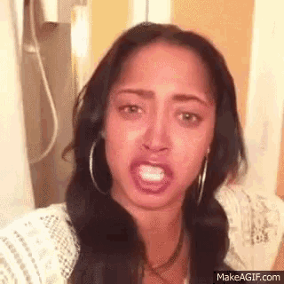a woman is making a funny face while taking a selfie .