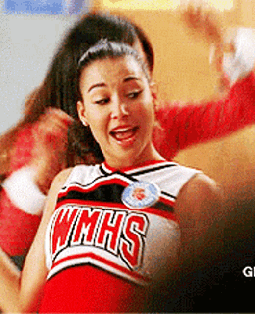 a cheerleader wearing a wmhs uniform is dancing
