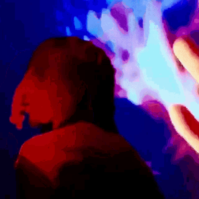 a painting of a person in a dark room with a blue and red background