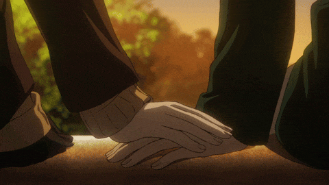 a couple holding hands with their feet visible in the background