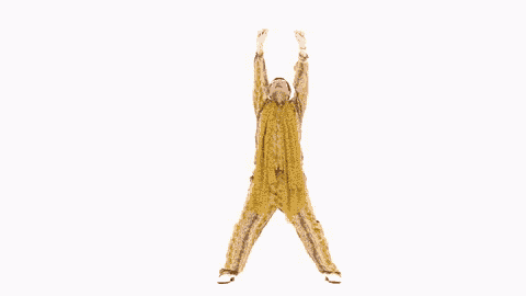 a man in a yellow jumpsuit is jumping in the air