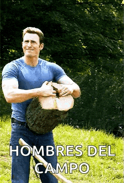 a man is holding a large log and a shovel in his hands .