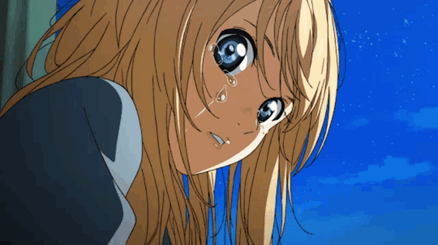 a girl with long blonde hair and blue eyes is crying