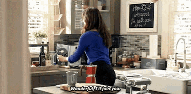 a woman in a kitchen says wonderful i 'll join you .