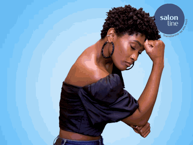 a woman wearing hoop earrings stands in front of a blue background that says salon line on it