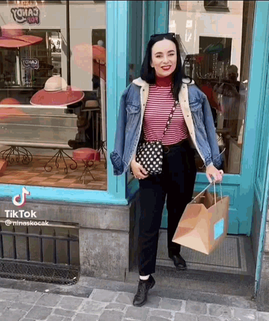 a woman is standing in front of a store with a tiktok watermark
