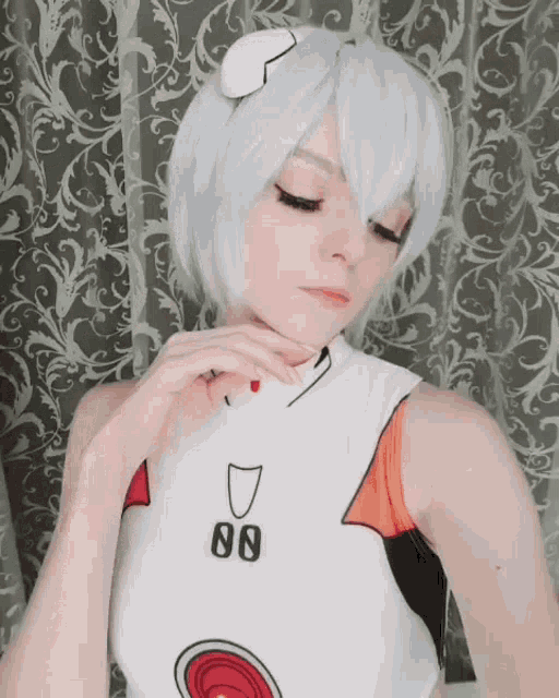 a woman wearing a white top with the number 88 on the front