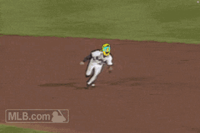 a baseball player is laying on the ground with a mlb.com logo in the corner