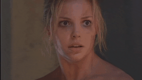 a close up of a woman 's face with a surprised expression .