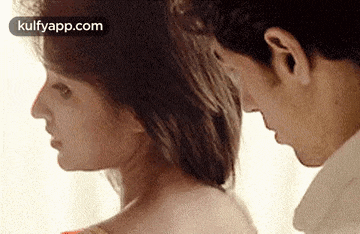 a man and woman are looking at each other .