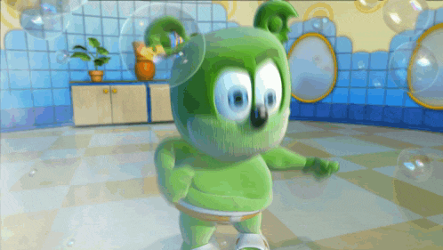 a green gummy bear is dancing in a bathroom with bubbles