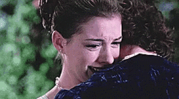 a man is hugging a woman who is crying .
