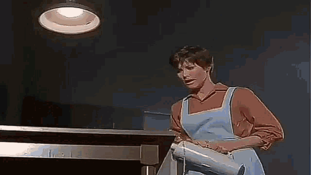a couple of people standing next to each other on a table with a blue background .