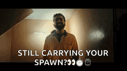 a man with a beard is standing in front of a door and says still carrying your spawn